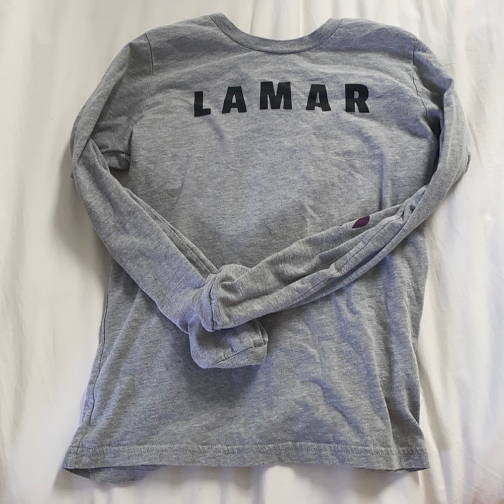 lamar ravens shirt with footballs on the elbow